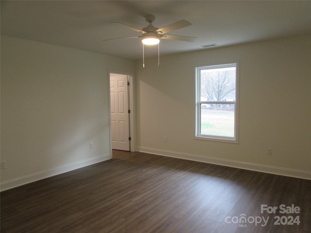 unfurnished room featuring ceiling fan and dark hardwood / wood-style flooring