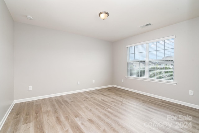 spare room featuring light wood-type flooring