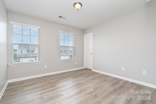 spare room with light hardwood / wood-style floors