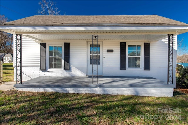 exterior space featuring a porch and a front lawn