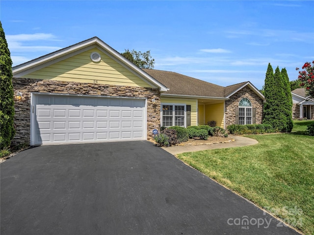 ranch-style home featuring a garage, a front yard, stone siding, and driveway