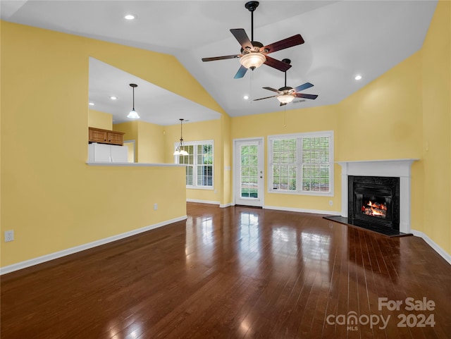 unfurnished living room featuring ceiling fan, vaulted ceiling, hardwood / wood-style flooring, and a fireplace