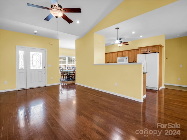 unfurnished living room featuring ceiling fan, vaulted ceiling, and hardwood / wood-style flooring