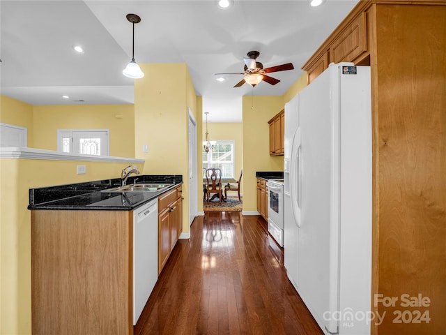 kitchen with sink, pendant lighting, dark hardwood / wood-style flooring, white appliances, and ceiling fan