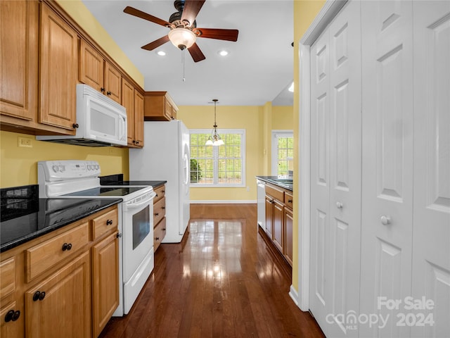 kitchen featuring ceiling fan, dark hardwood / wood-style floors, hanging light fixtures, and white appliances