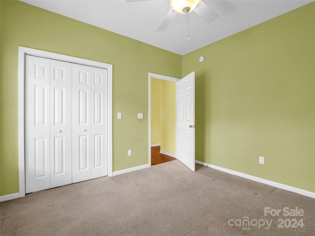 unfurnished bedroom featuring ceiling fan, carpet flooring, and a closet