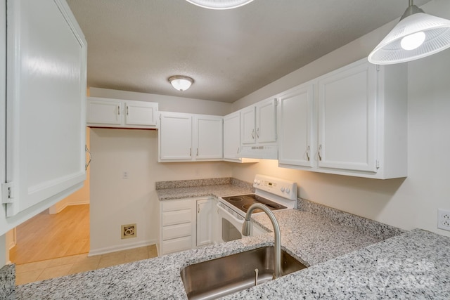 kitchen featuring hanging light fixtures, under cabinet range hood, white cabinetry, and electric stove