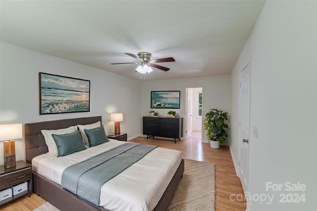 bedroom with a ceiling fan and light wood-style floors