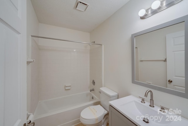 bathroom featuring bathtub / shower combination, visible vents, toilet, a textured ceiling, and vanity