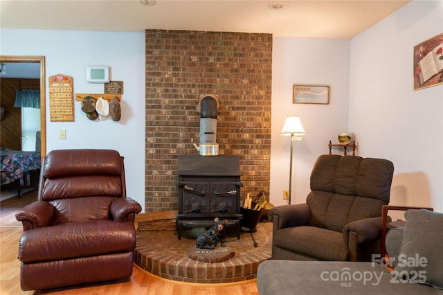 living room featuring a wood stove and hardwood / wood-style flooring