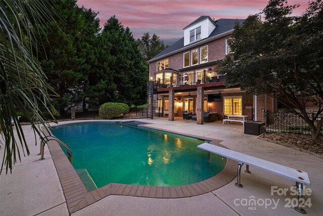 view of pool with a fenced in pool, a patio area, fence, and stairway