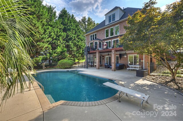 view of pool with a patio, area for grilling, fence, and a fenced in pool