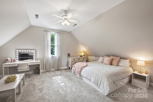 bedroom with lofted ceiling, carpet flooring, and visible vents