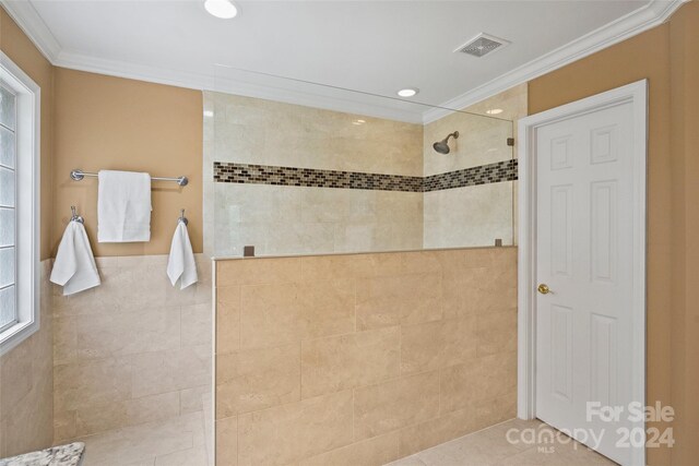 full bath featuring crown molding, tile walls, recessed lighting, visible vents, and a walk in shower