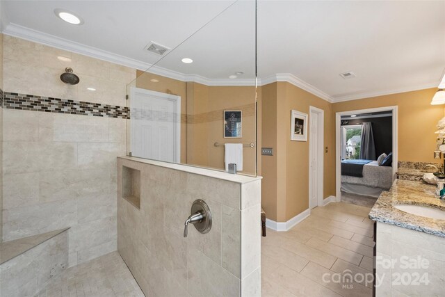 full bath featuring ornamental molding, visible vents, connected bathroom, and a walk in shower