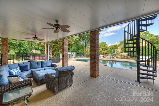 view of patio featuring a fenced in pool, a ceiling fan, stairway, fence, and an outdoor living space