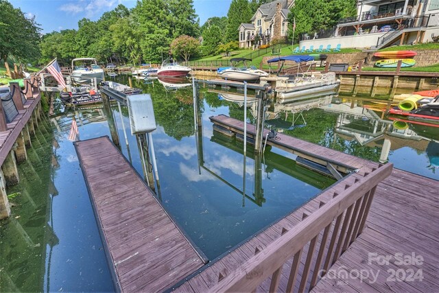 dock area with a water view and boat lift