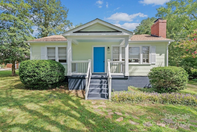 bungalow-style home featuring a front yard and a porch