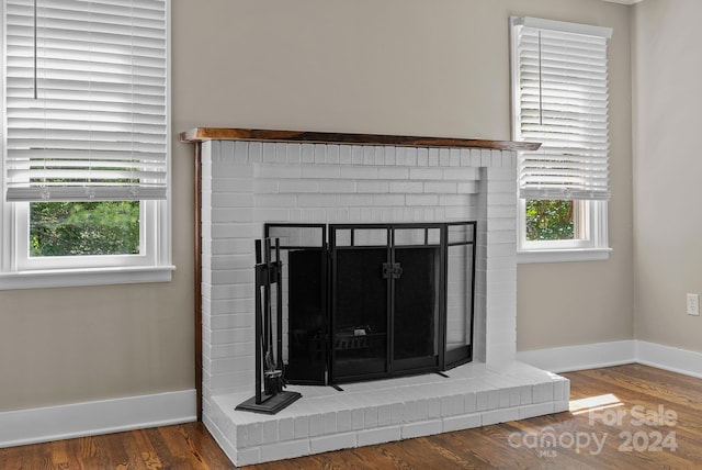 room details with hardwood / wood-style floors and a fireplace