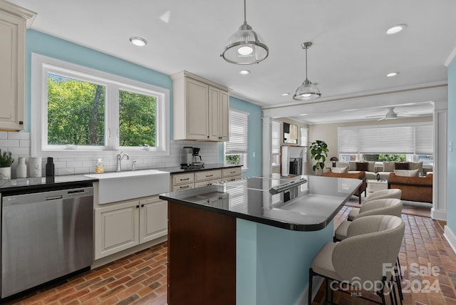 kitchen featuring pendant lighting, a healthy amount of sunlight, stainless steel dishwasher, and ceiling fan