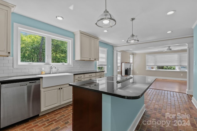 kitchen with pendant lighting, a wealth of natural light, a kitchen island, and stainless steel dishwasher