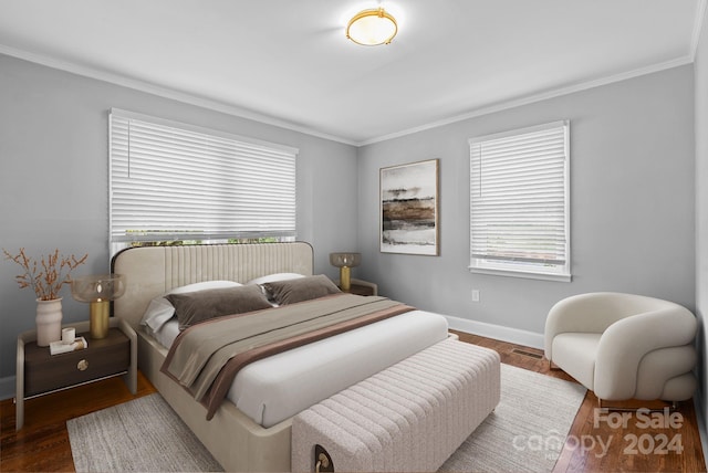 bedroom with hardwood / wood-style flooring and crown molding