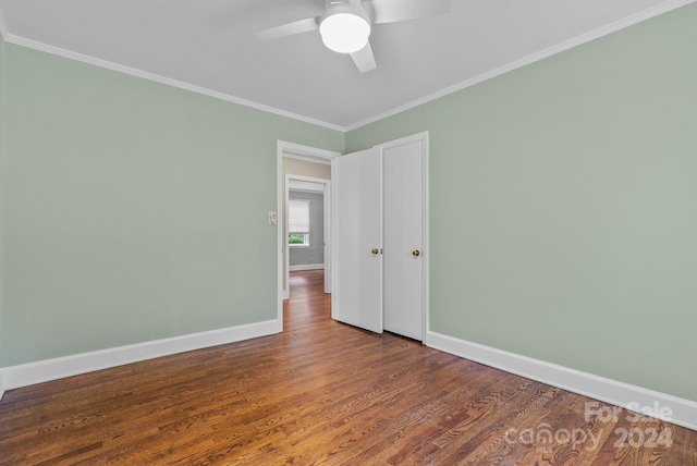 spare room with ornamental molding, ceiling fan, and dark hardwood / wood-style floors