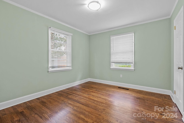 unfurnished room with hardwood / wood-style flooring and crown molding