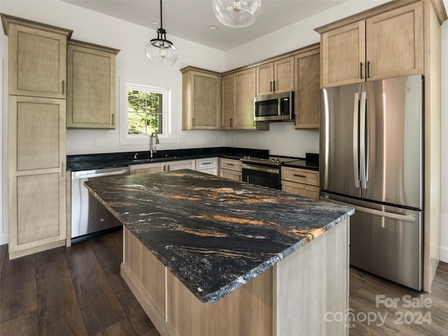 kitchen with dark wood-type flooring, light brown cabinetry, sink, pendant lighting, and stainless steel appliances