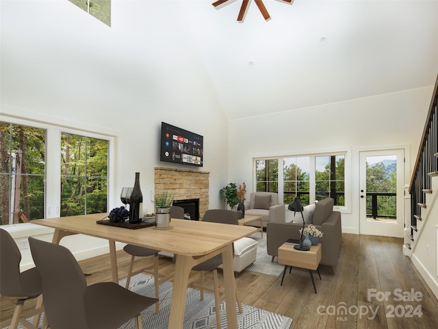 living room featuring hardwood / wood-style flooring, a fireplace, and high vaulted ceiling