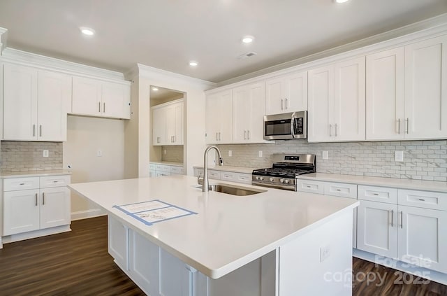 kitchen with white cabinetry, appliances with stainless steel finishes, and a sink