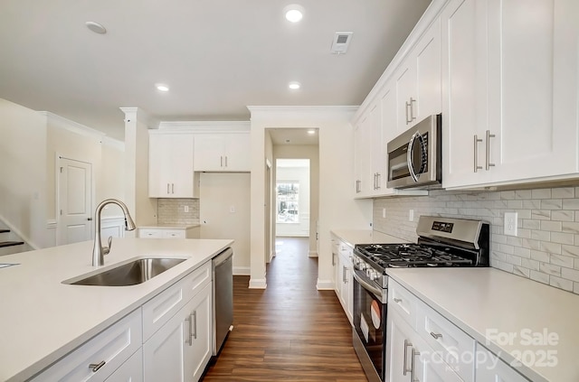 kitchen featuring stainless steel appliances, light countertops, visible vents, and a sink