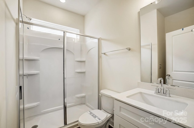 full bath featuring a shower stall, toilet, and vanity