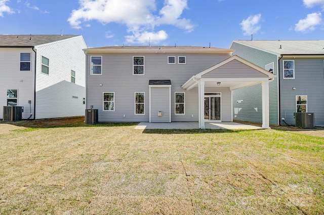 rear view of property featuring a patio, central AC unit, and a lawn