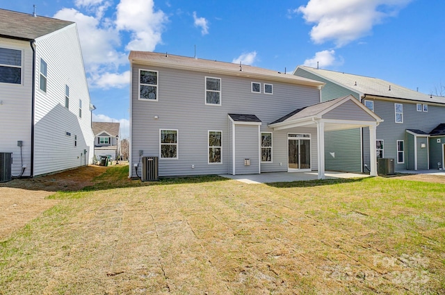 back of property with central AC, a patio, and a lawn