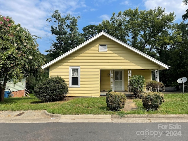 bungalow-style house with a front yard