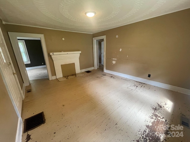 unfurnished living room featuring a textured ceiling, a fireplace, and wood-type flooring