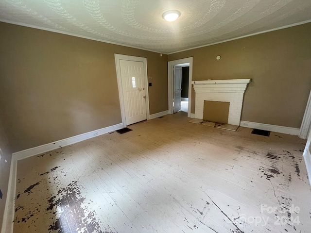 unfurnished living room with hardwood / wood-style flooring and a brick fireplace