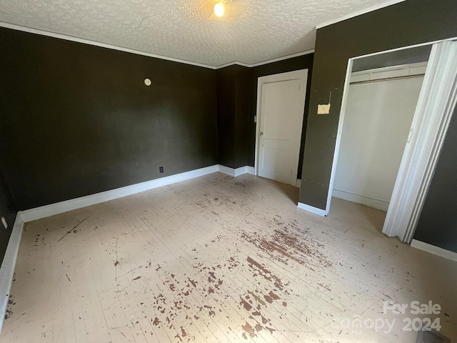 unfurnished bedroom with a textured ceiling