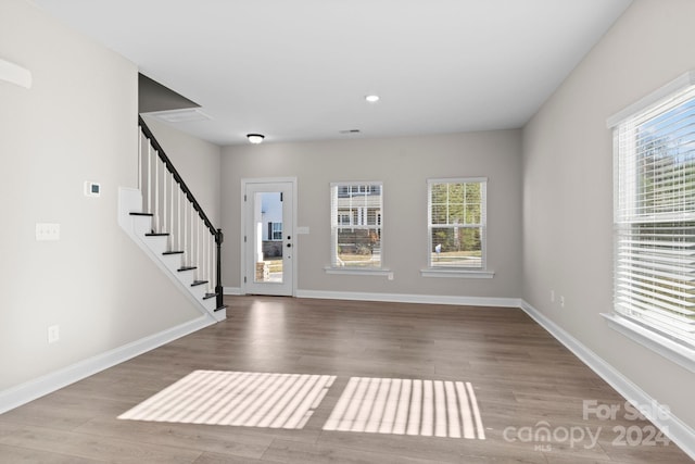 foyer entrance with a wealth of natural light and light wood-type flooring