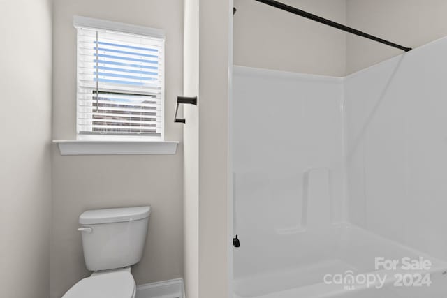 bathroom featuring toilet and walk in shower