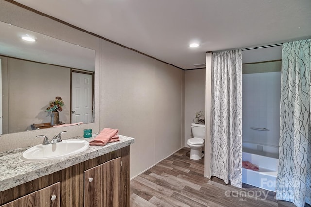 full bathroom featuring shower / bath combination with curtain, vanity, toilet, and hardwood / wood-style flooring