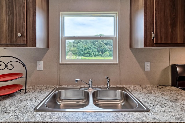 kitchen featuring dark brown cabinetry and sink