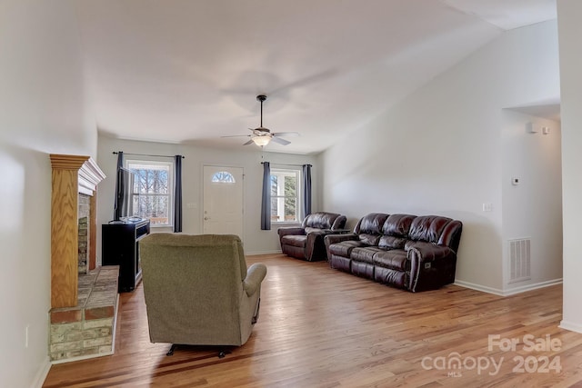 living room featuring ceiling fan and light hardwood / wood-style floors