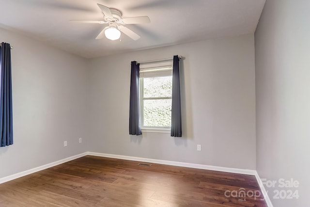 unfurnished room featuring ceiling fan and hardwood / wood-style flooring