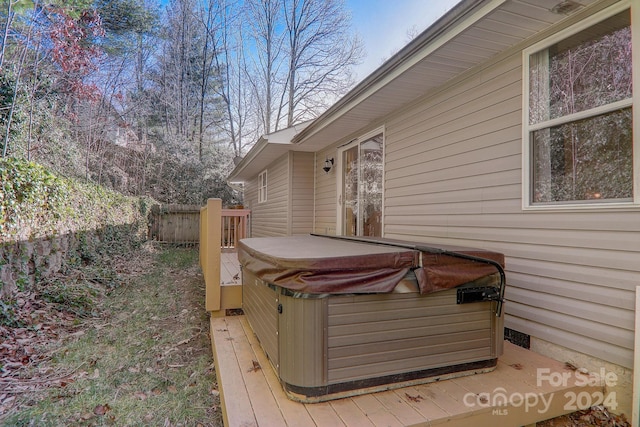 wooden deck with a hot tub