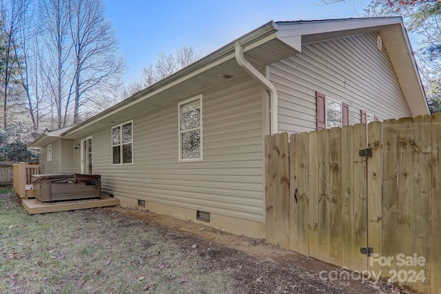 view of side of property with a hot tub