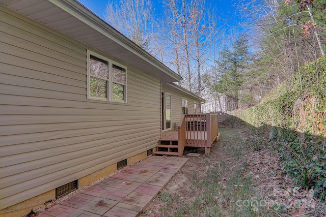 view of side of home with a wooden deck