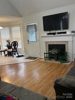 living room with hardwood / wood-style flooring and lofted ceiling