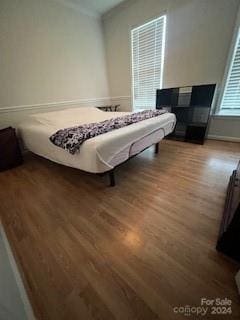 bedroom with hardwood / wood-style flooring